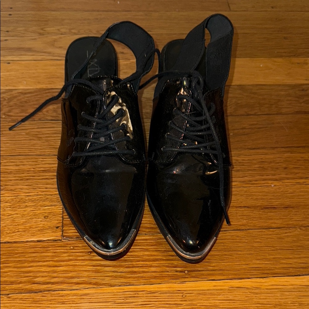 Black oxfords with patent leather and a steel toe Finish and Traditional Lacing
